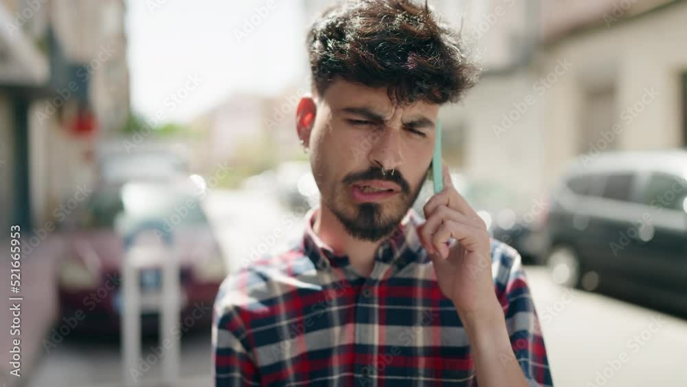 Young hispanic man standing with worried expression at street Young hispanic man standing with worried expression at street