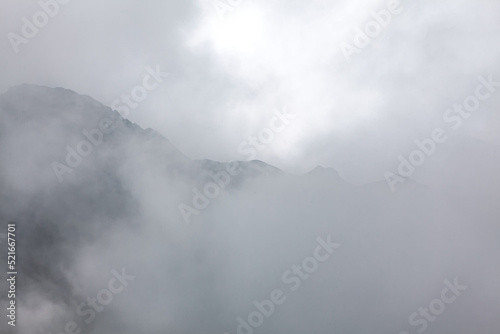 Foggy mountains scenery . Clouds over mountain peaks