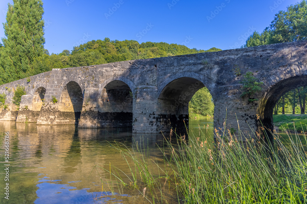 The old stone bridge on the Dobra River, Croatia