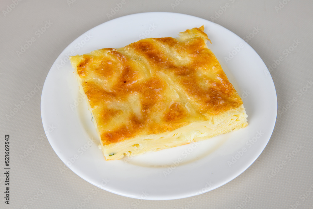 Turkish style meat stuffed filo dough borek served kol boregi. Cheese and minced pie are sliced on a marble background. Turkish name: Kol Boregi, kiymali, peynirli su boregi. Turkish style meat stuffed filo dough borek served kol boregi. Cheese and minced pie are sliced on a marble background. Turkish name: Kol Boregi, kiymali, peynirli su boregi.