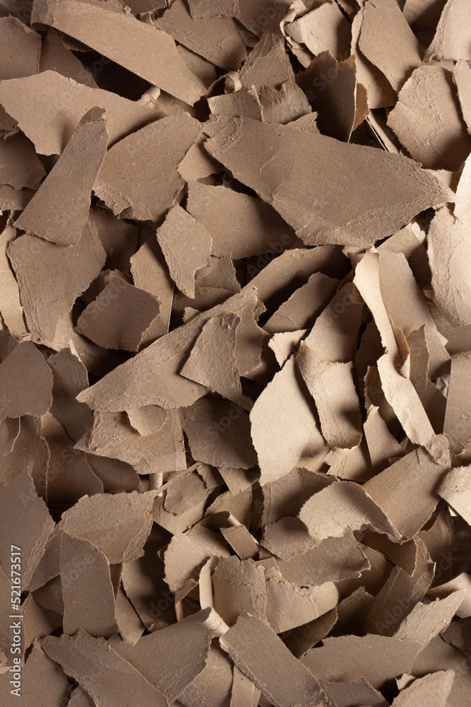 Torn paper heap as background. Recycling concept and waste cardboard