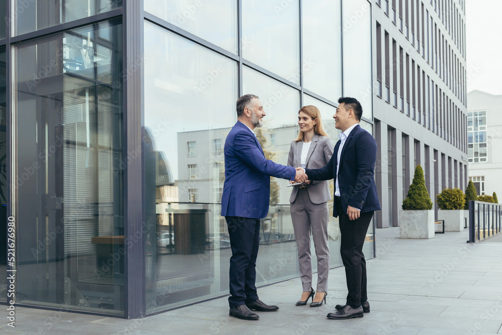 Business meet, colleagues happy team meet outside office, greet shake hands, diverse employees in business suit, man and woman business people Business meet, colleagues happy team meet outside office, greet shake hands, diverse employees in business suit, man and woman business people