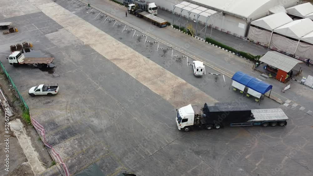 4K over Semi Trucks in the Warehouse during transportation on the leading commodity. Photo of logistic from Aerial View. 4K over Semi Trucks in the Warehouse during transportation on the leading commodity. Photo of logistic from Aerial View.