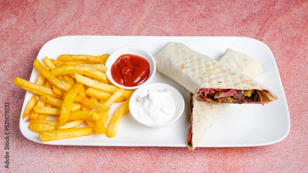 Foto de Beef durum kebab french fries, ketchup and mayonnaise. Beef