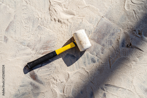 Rubber mallet on sandy ground. Construction of a footpath. Space