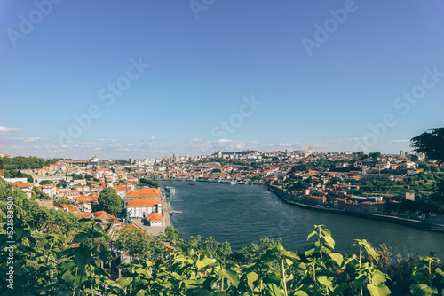 River view of Porto city from green park and sun shine on houses 