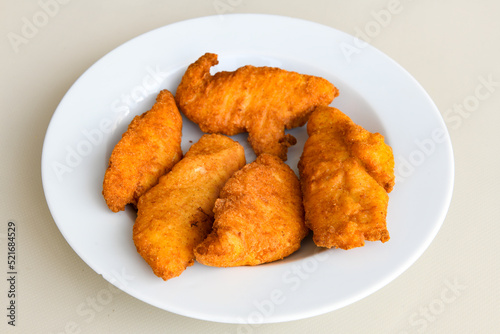 Fried Chicken breast hot crispy strips crunchy chicken tenders isolated on white background.Nuggets isolated on white background on a plate