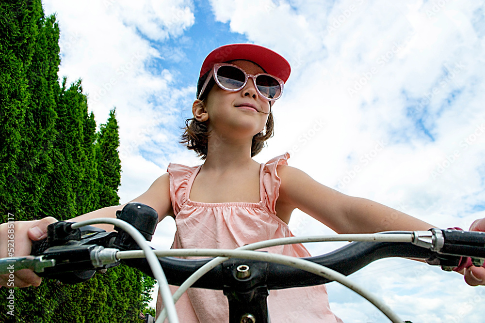 Naklejka premium Girl has damaged bicycle wheel and making repairs