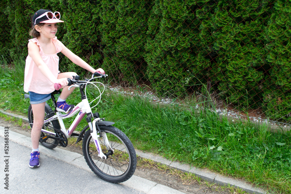 Fototapeta premium Girl has damaged bicycle wheel and making repairs