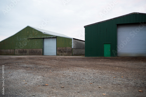 Farm barns and farm yard corrugated green countryside view © AJPS
