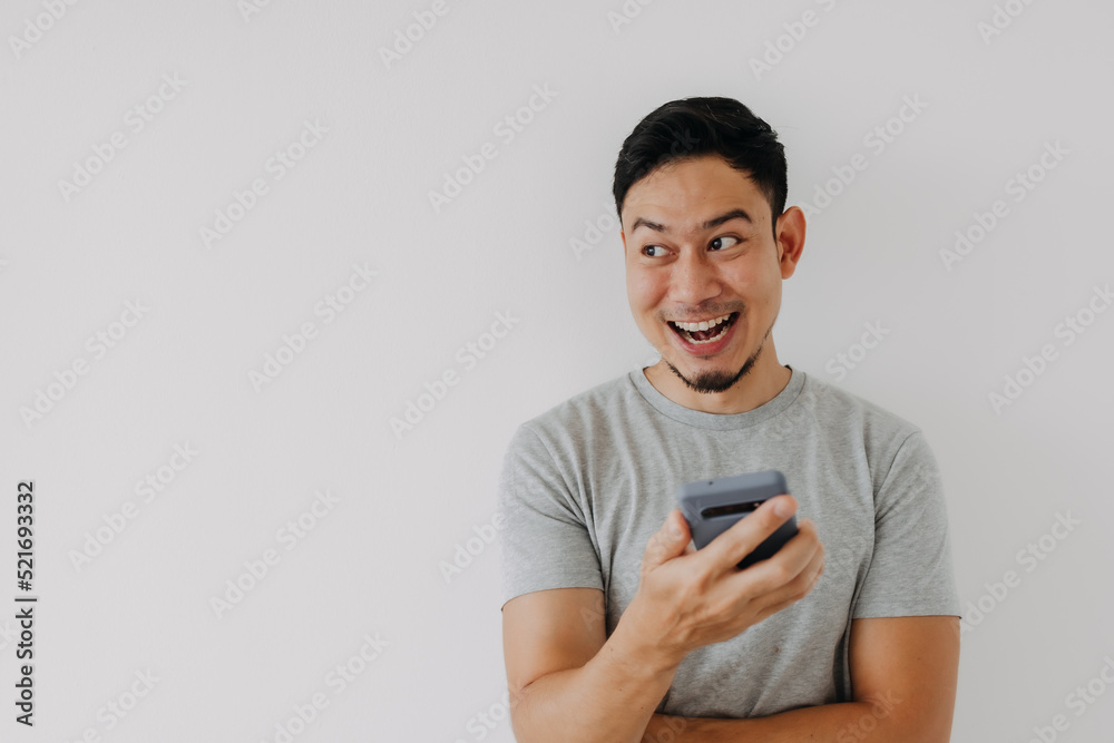 Wow and surprise face asian man use smartphone with copy space of advertisement. Wow and surprise face asian man use smartphone with copy space of advertisement.