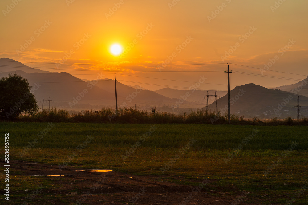 Obraz premium Fabulous sunset landscape with field and mountains, Armenia