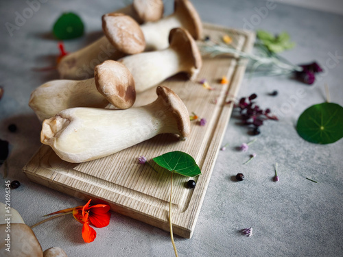 Porcini and Chanterelle Musrooms on the black cutting board and woodern board on the table.  photo