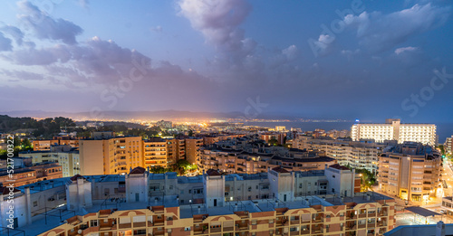 Panorama aerial view of Torremolinos cityscape at dusk and Malaga bay in Costa del Sol, Spain photo