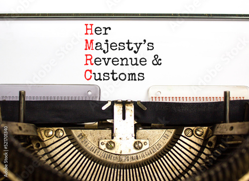 HMRC her majestys revenue and customs symbol. Concept words HMRC her majestys revenue and customs typed on the retro old typewriter. Business HMRC revenue and customs concept. Copy space. photo