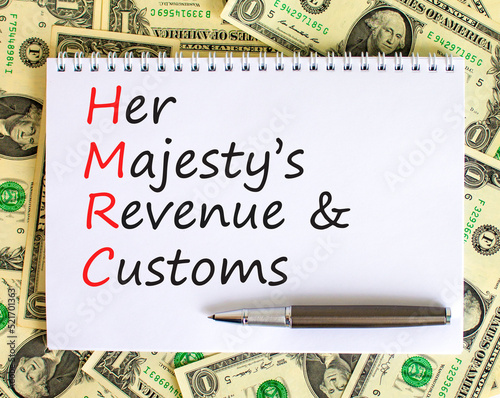 HMRC her majestys revenue and customs symbol. Concept words HMRC her majestys revenue and customs on white note on beautiful dollar background. Business HMRC revenue and customs concept. Copy space. photo