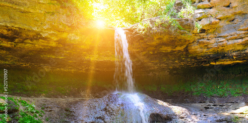 Beautiful waterfall in the forest and sun, Republic of Moldova Wide photo.