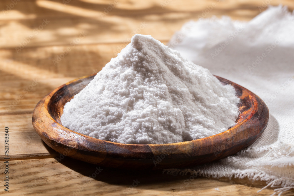Baking soda in wooden bowl on the table Baking soda in wooden bowl on the table