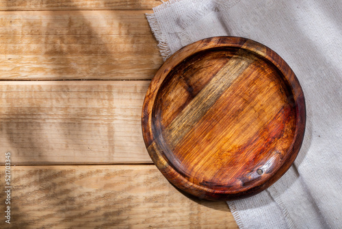 Circular shaped wooden bowl on the table, top view