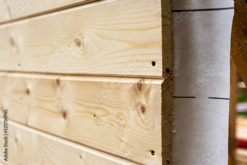 cladding of a wooden frame house with clapboard and vapor barrier. Construction of houses. photo