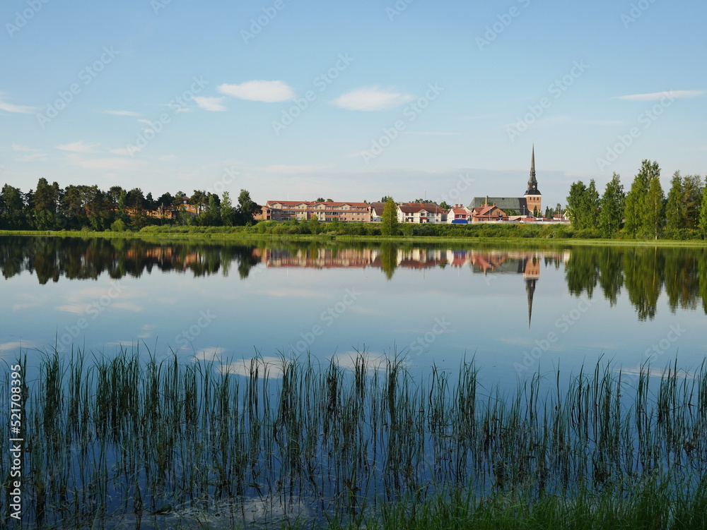 Mora Församling Church in Sweden reflecting in the Water on a bright morning.