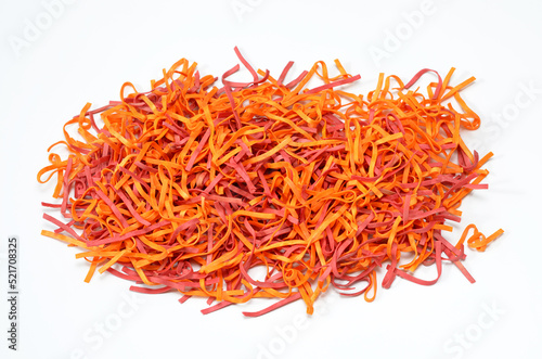 colorful tagliolini pasta with beet extract and chili pepper isolated on white background