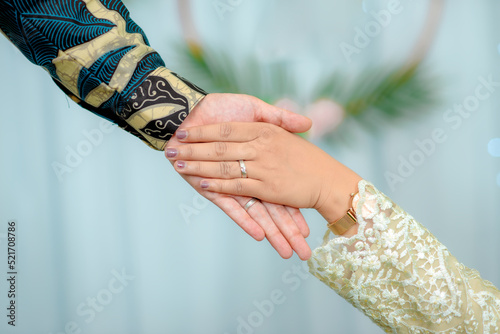 Portrait of a pair of male and female hands with wedding rings. The day of the wedding ceremony. Hands of a newly married couple with wedding rings.