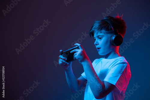 Boy with a phone in his hands in neon light © stenkovlad