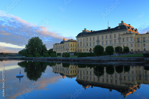 The Drottningholm palace. At sunset with reflection in the calm water. One old historic Swedish castle. Stockholm, Sweden.