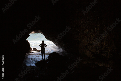 silhouette of a person in a cave