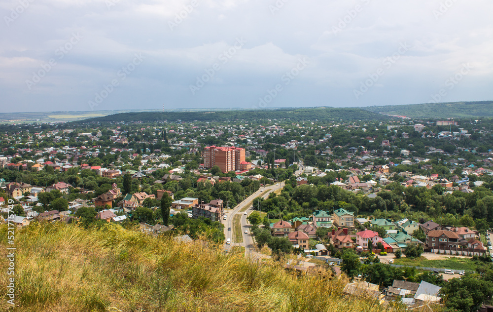 Panoramic top view of the city of Pyatigorsk in Russia on a cloudy summer day and a copy space on the horizon