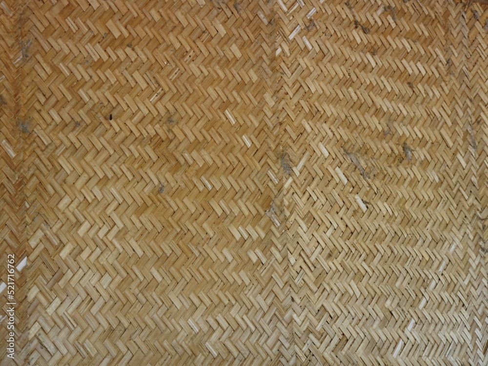 Woven bamboo used as a divider in a room Woven bamboo used as a divider in a room