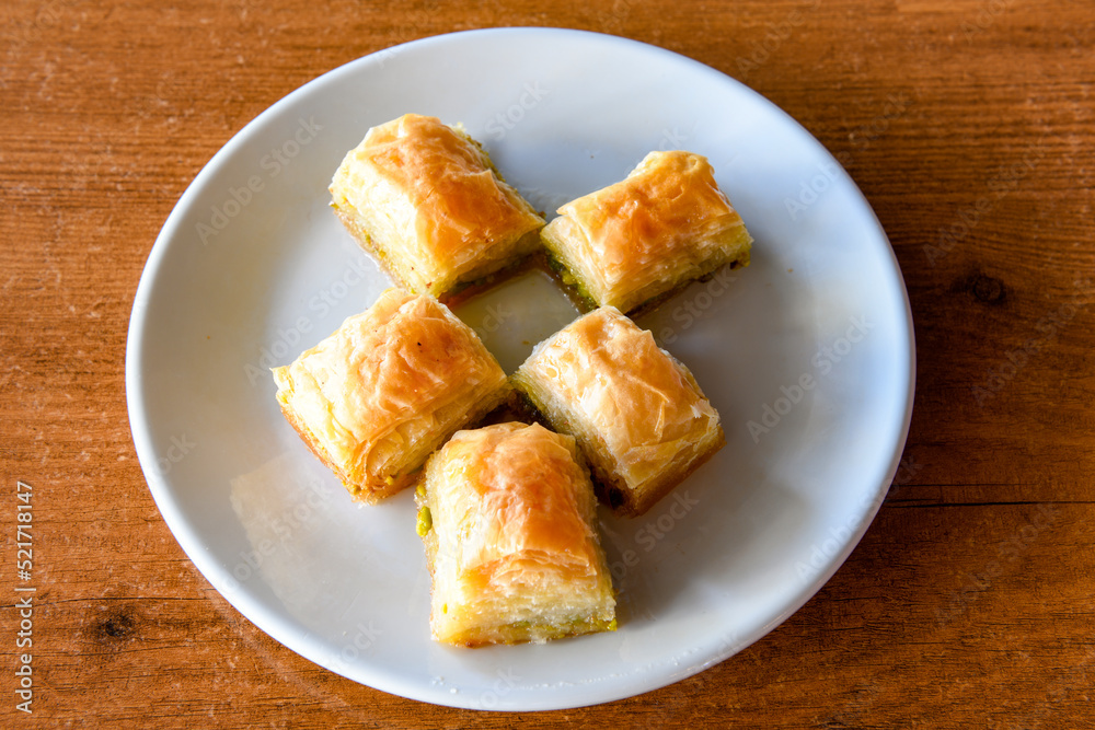 Turkish Dessert Sobiyet Baklava, mussels baklava and classic baklava with Pistachio . Cevizli, Fistikli Baklava, top view. Turkish Dessert Sobiyet Baklava, mussels baklava and classic baklava with Pistachio . Cevizli, Fistikli Baklava, top view.