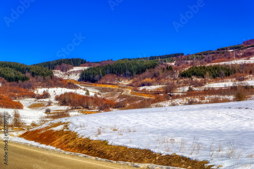 Mountain landscape in Bosnia and Herzegovina covered with snow during sunny winter day.