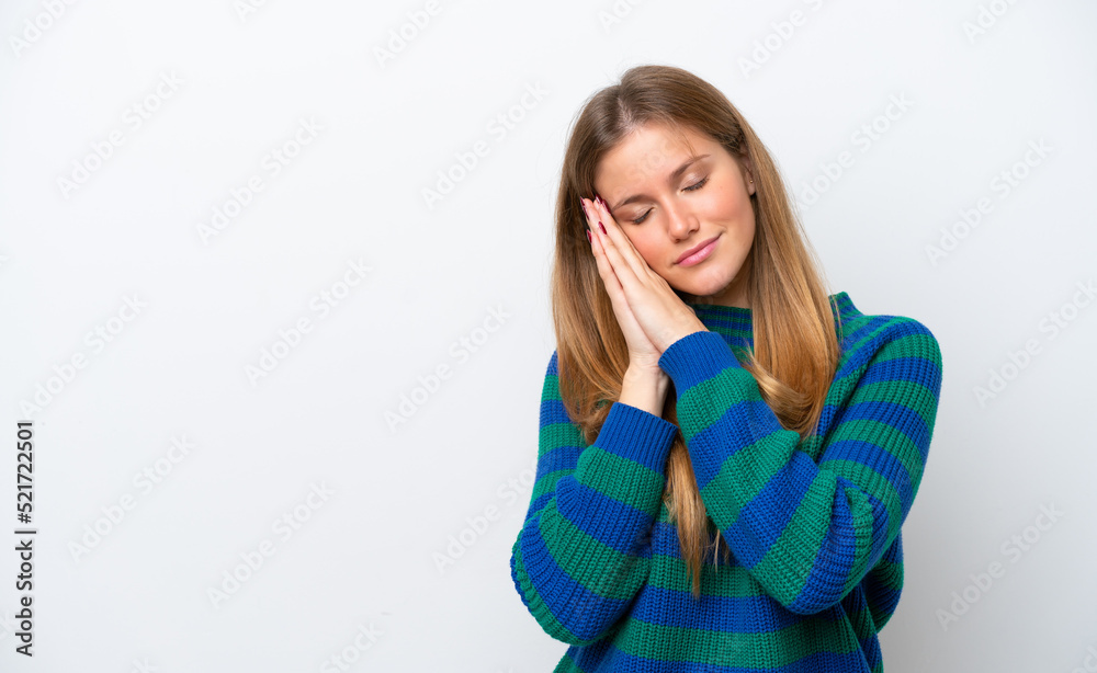 Young caucasian woman isolated on white background making sleep gesture in dorable expression Young caucasian woman isolated on white background making sleep gesture in dorable expression