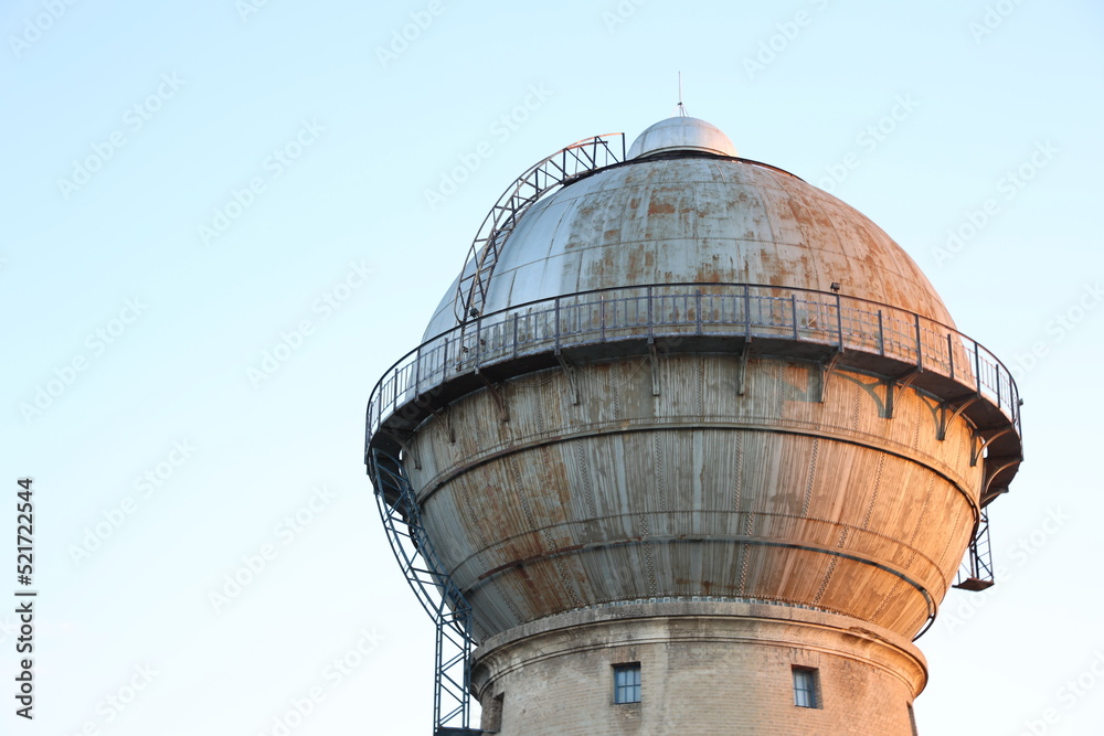 Building with round dome old water tower near railroad Building with round dome old water tower near railroad