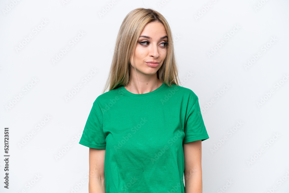 Pretty blonde woman isolated on white background making doubts gesture looking side Pretty blonde woman isolated on white background making doubts gesture looking side