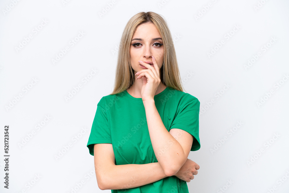 Pretty blonde woman isolated on white background surprised and shocked while looking right Pretty blonde woman isolated on white background surprised and shocked while looking right