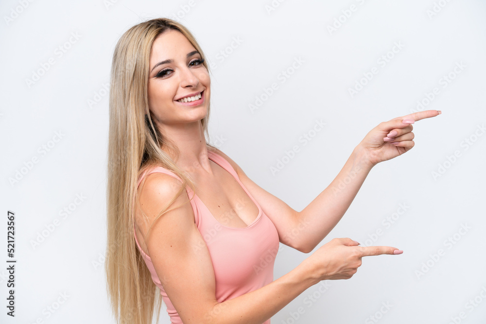 Pretty blonde woman isolated on white background pointing finger to the side and presenting a product Pretty blonde woman isolated on white background pointing finger to the side and presenting a product