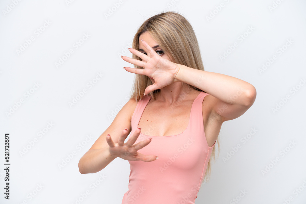 Pretty blonde woman isolated on white background nervous stretching hands to the front Pretty blonde woman isolated on white background nervous stretching hands to the front