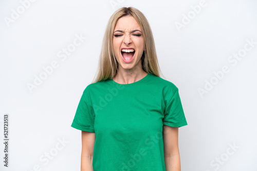 Pretty blonde woman isolated on white background shouting to the front with mouth wide open