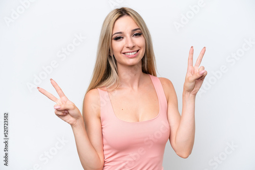 Pretty blonde woman isolated on white background showing victory sign with both hands