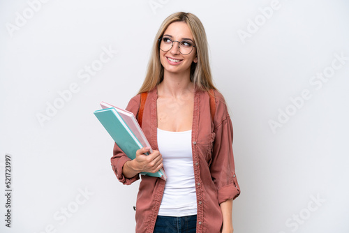 Pretty student blonde woman isolated on white background thinking an idea while looking up