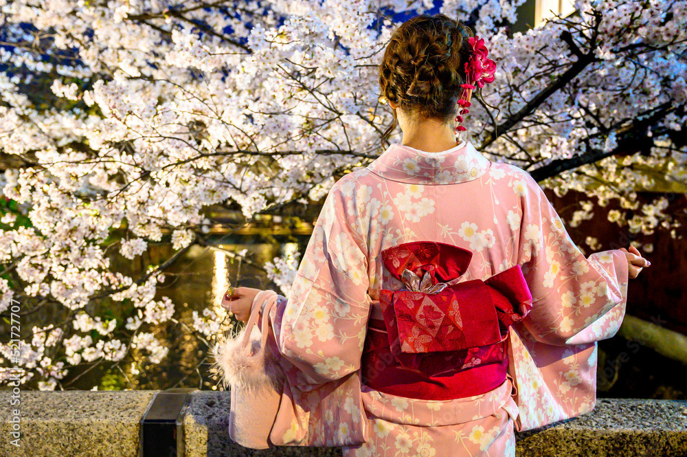 Japanese woman in kimono during cherry blossom Japanese woman in kimono during cherry blossom