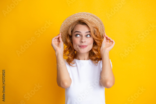 Excited amazed woman in straw hat isolated on yellow studio background.