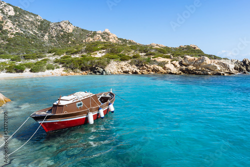 Fishing boat at the coast in crystal clear water