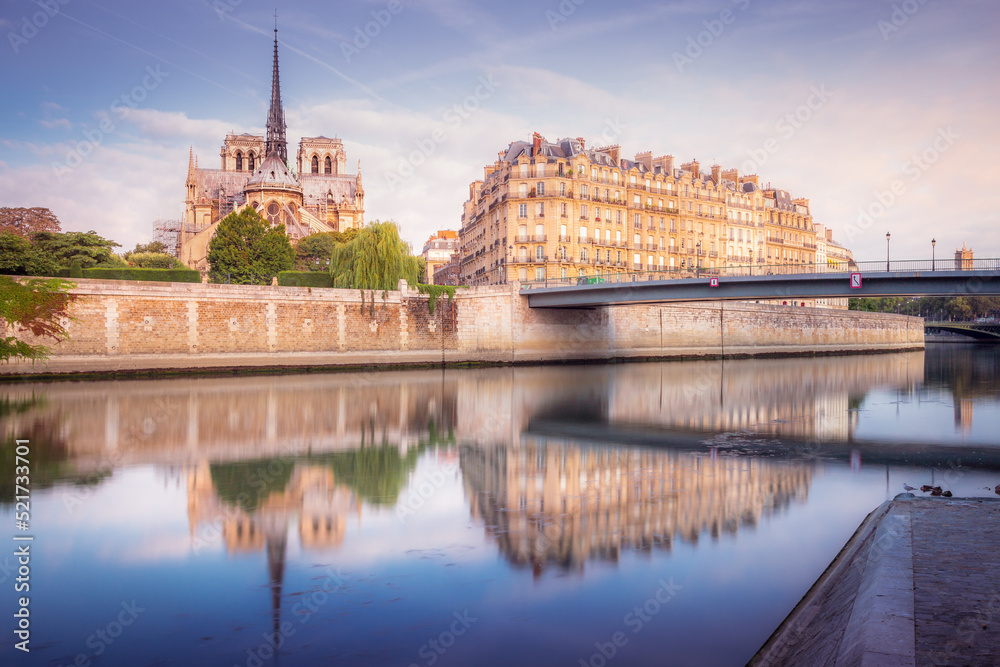 Notre Dame of Paris on Seine River reflection at sunrise, France