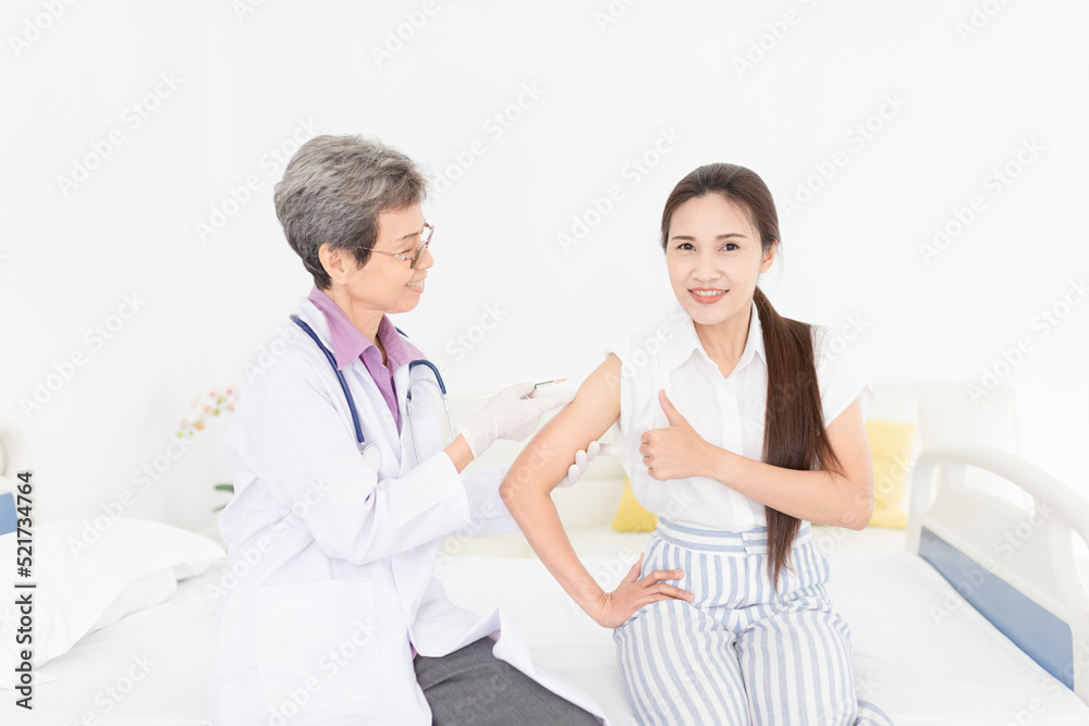 doctor inject vaccine to asian woman, Deltoid muscle injection technique, immunization and health care promotion doctor inject vaccine to asian woman, Deltoid muscle injection technique, immunization and health care promotion