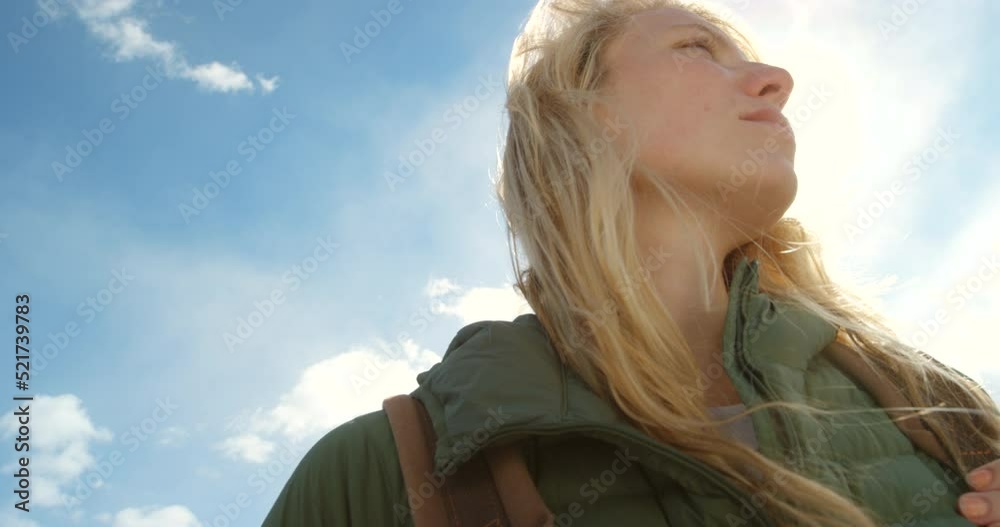 Adventure and freedom with a beautiful, young and carefree woman against a blue sky from below. Enjoying the mountain view, scenery and freedom that comes with exploration and a journey of discovery Adventure and freedom with a beautiful, young and carefree woman against a blue sky from below. Enjoying the mountain view, scenery and freedom that comes with exploration and a journey of discovery