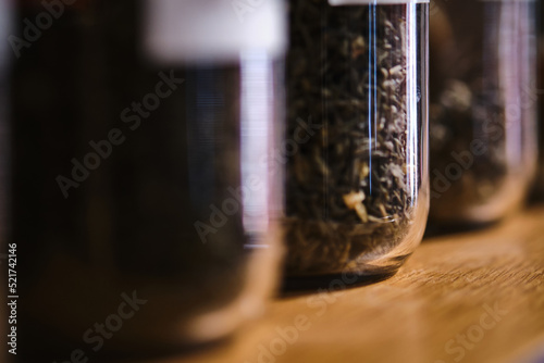 Glass containers with tea brews. Abstract background. photo